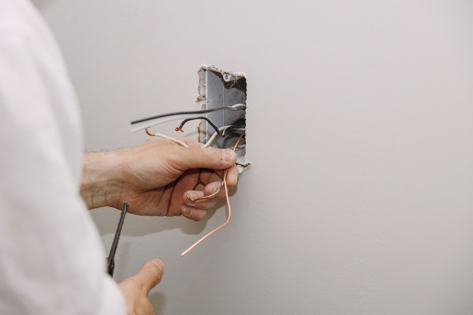 Unfinished electrical mains outlet socket with electrical wires and connector installed in
